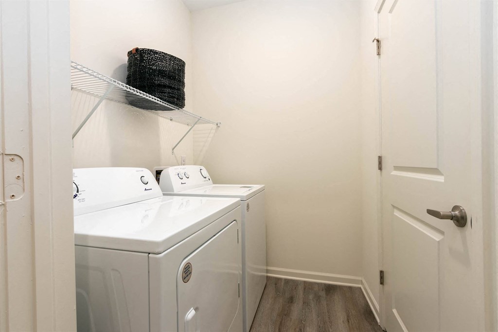 a washer and dryer in a room with a door at Capstone at Banks Crossing, Georgia