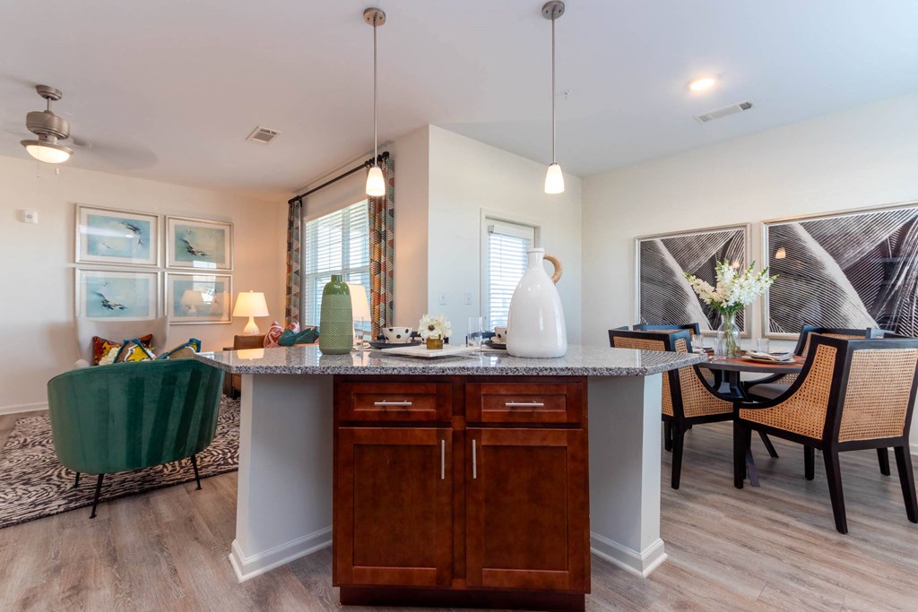 a kitchen and living room with a table and chairs at Capstone at Banks Crossing, Georgia