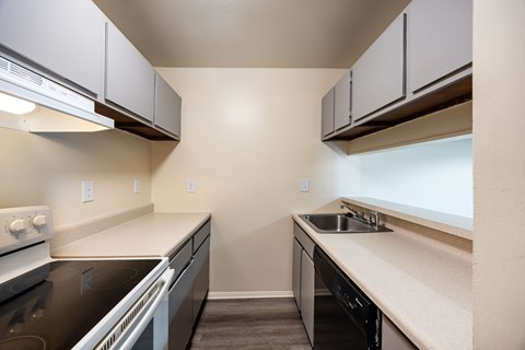 A kitchen with black countertops and white appliances.