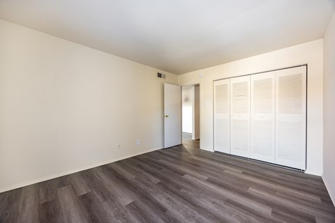 A room with a wooden floor and white walls.