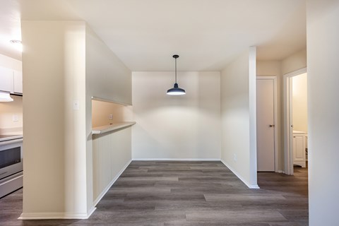 A long, empty hallway with a light hanging from the ceiling.