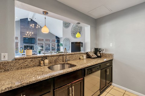 a kitchen with a granite counter top and a sink