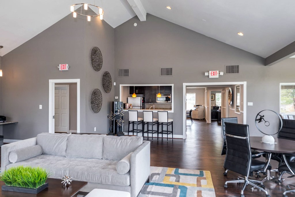 a living room with gray walls and a vaulted ceiling at Misty Ridge Apartments, Woodbridge
