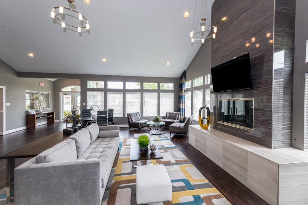 a large living room with a large fireplace and a large tv on the wall at Misty Ridge Apartments, Woodbridge Virginia