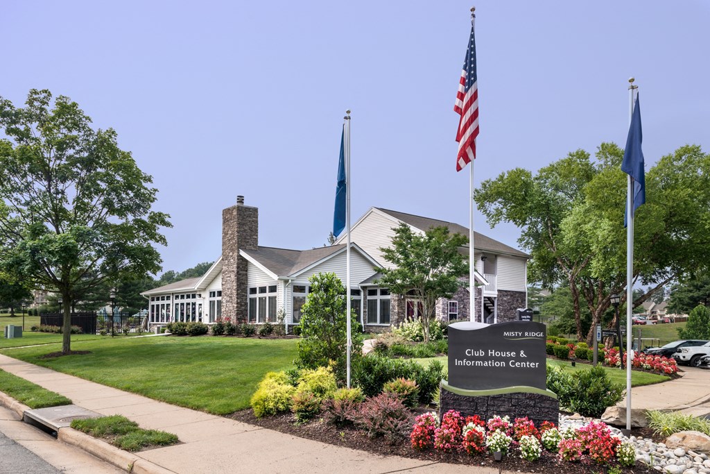 a building with an american flag and a sign in front of it at Misty Ridge Apartments, Virginia