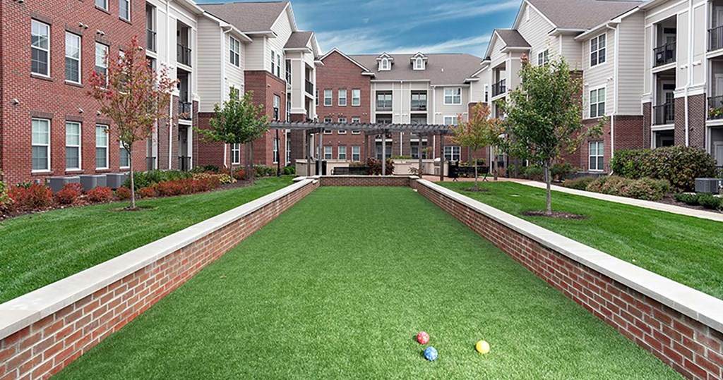 a bocce court in front of an apartment building at Canopy at Ginter Park Apartments, Richmond, VA, 23227
