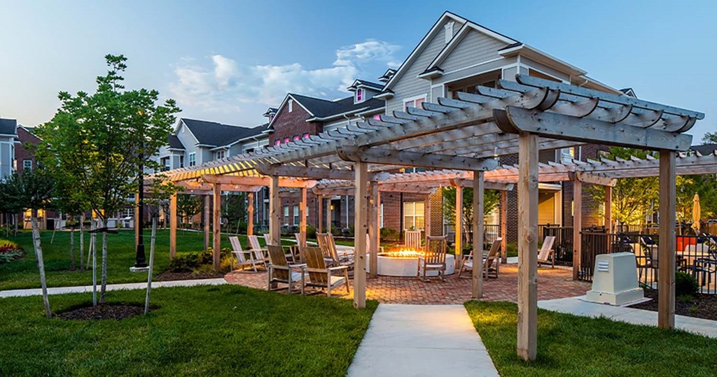 a patio with a pergola and lawn chairs at Canopy at Ginter Park Apartments, Richmond, VA, 23227