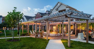 a patio with a pergola and lawn chairs at Canopy at Ginter Park Apartments, Richmond, VA, 23227
