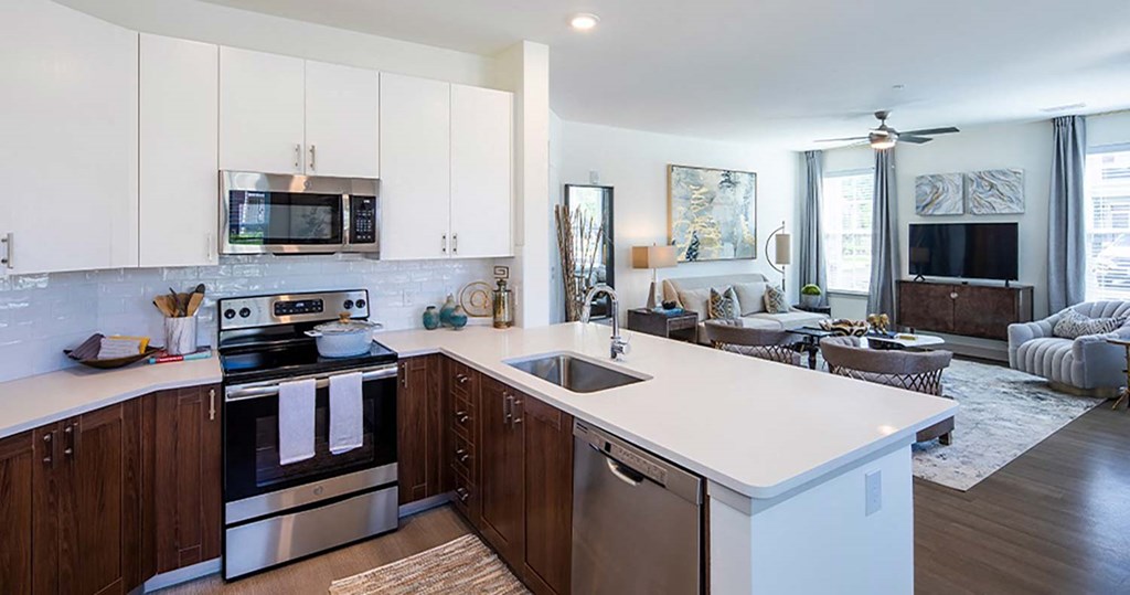 a kitchen with white cabinets and a white counter top