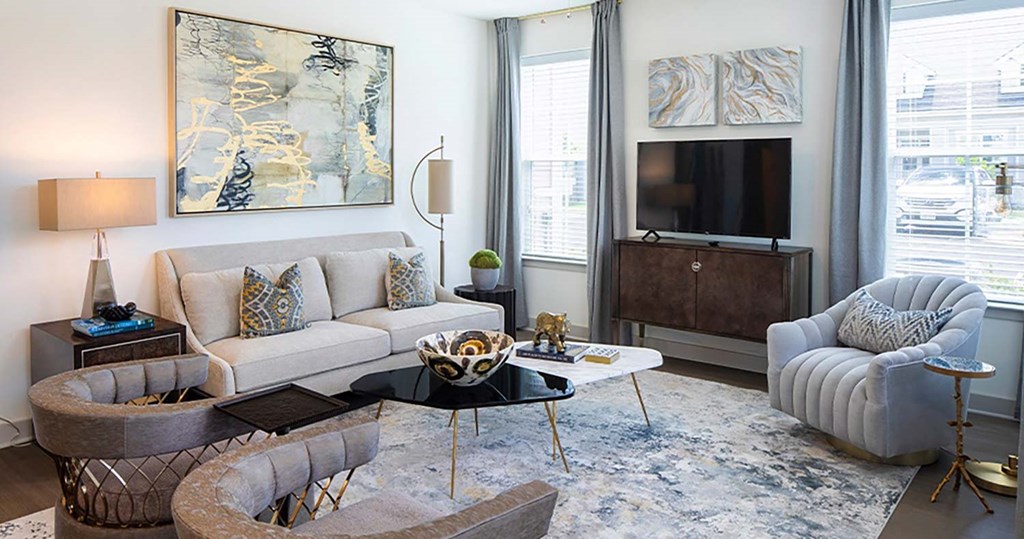 a living room filled with furniture and a large window