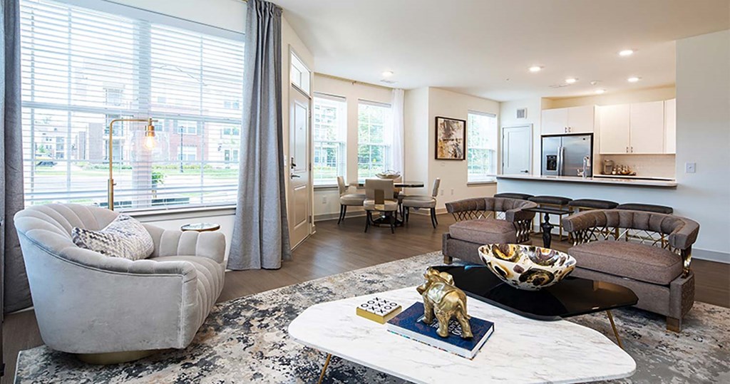 a living room filled with furniture and a large window