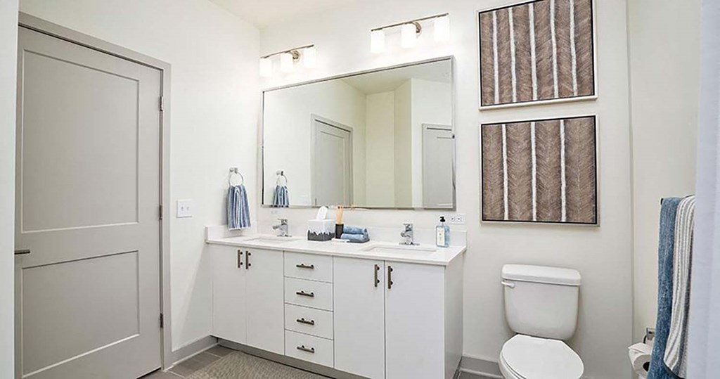 a bathroom with a toilet sink and a mirror