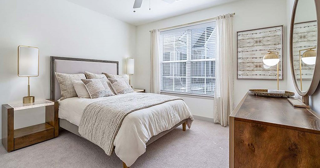 a bedroom with a bed and a window