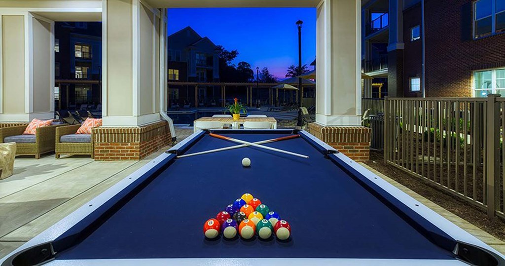 a blue pool table with a bunch of balls on it