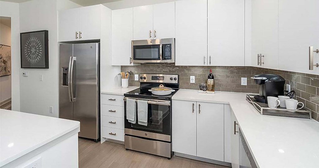 a kitchen with a stove top oven next to a refrigerator