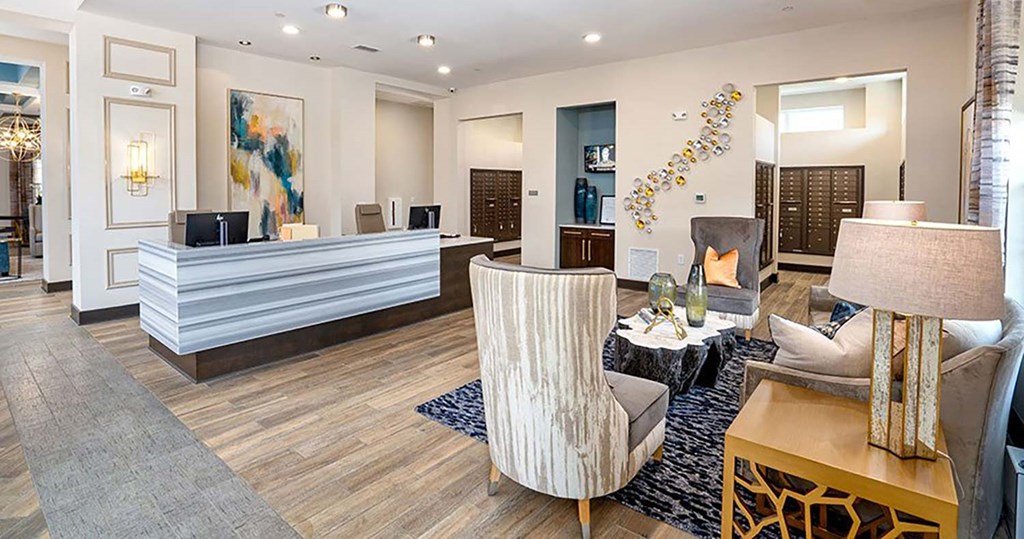 a spacious hotel lobby with a desk and chairs