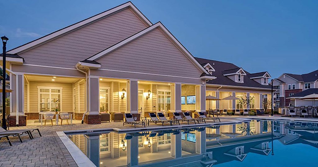 a house with a swimming pool in front of it