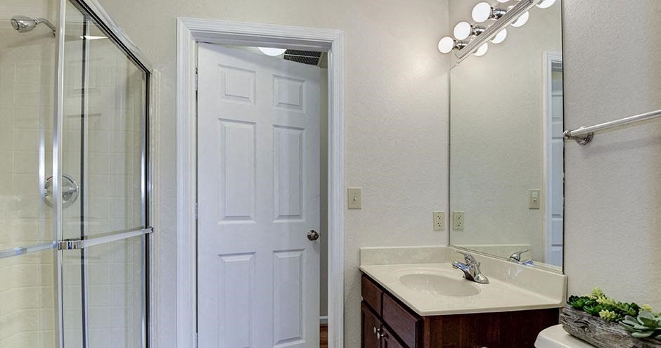 a bathroom with a sink mirror and shower at SomerHill Farms Apartments, Virginia , 20155