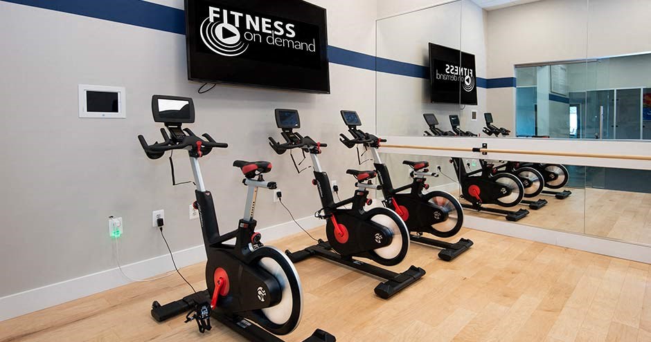a group of people riding on bikes in a gym at Bellemeade Farms Apartments, Leesburg, VA 20175