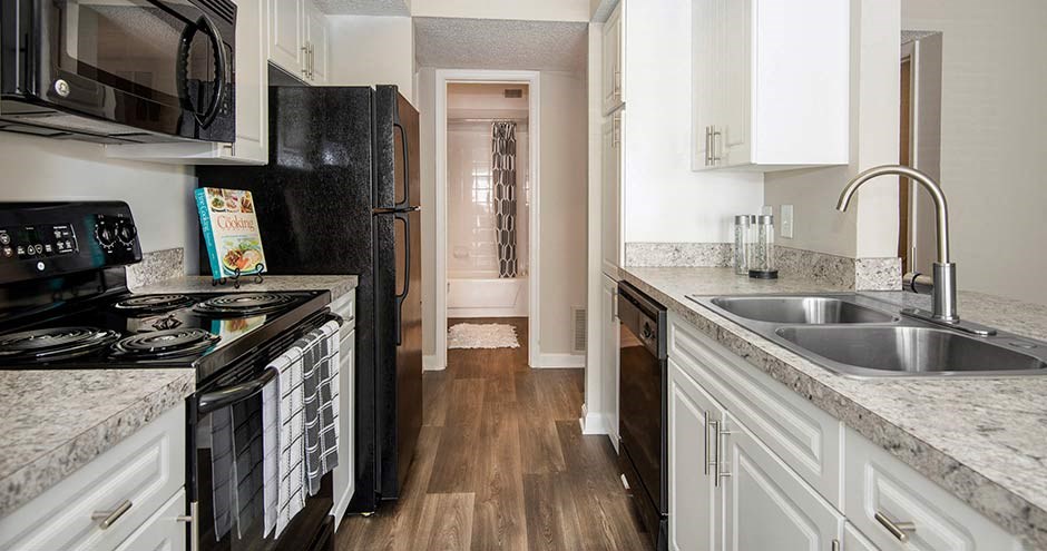 a kitchen with white cabinets and black appliances at Bellemeade Farms Apartments, Virginia