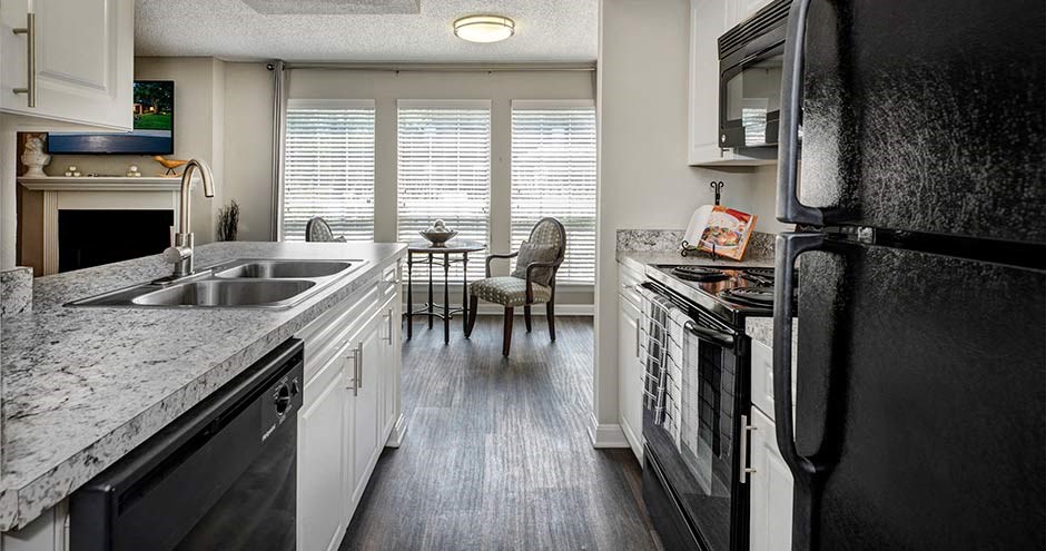 a kitchen with a stove top oven next to a sink at Bellemeade Farms Apartments, Leesburg, 20175