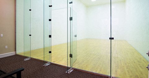 A room with a wooden floor and glass walls at Austin Chase Apartments, Georgia 31210