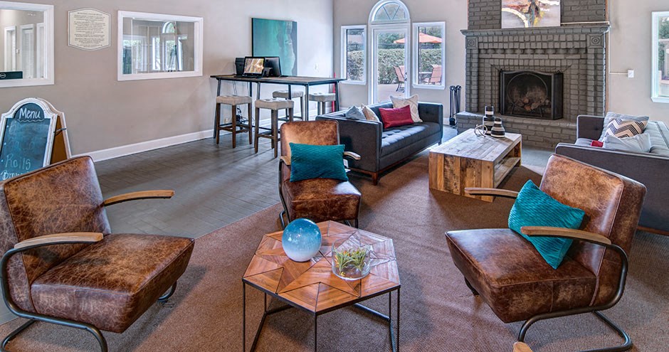 A living room with a fireplace and a couch at Southland Station Apartments, Warner Robins, 31088
