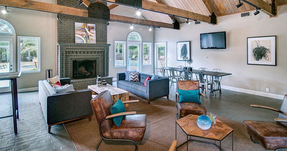 A living room with a fireplace and a television at Southland Station Apartments, Warner Robins, GA