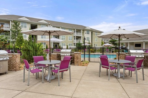 A patio with a table and chairs is in front of a building.