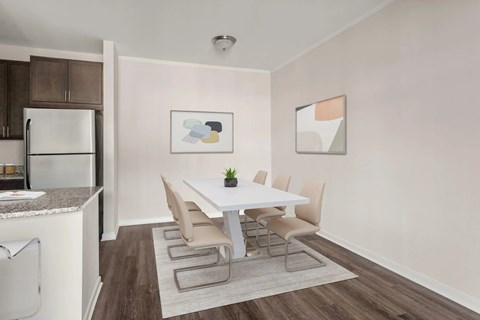 A dining room with a white table and chairs.