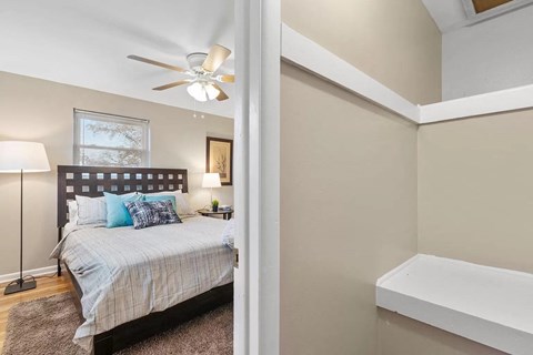 a bedroom with a bed and a ceiling fan