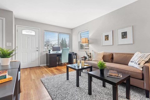 a living room with a couch and tables