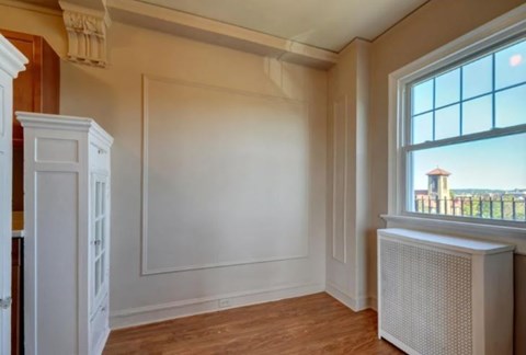 A room with a window and a radiator on the wall.