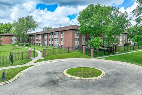 A large building with a circular driveway in front.