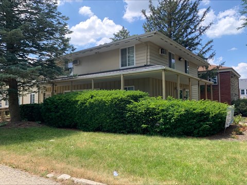A house with a well-maintained green lawn in front.