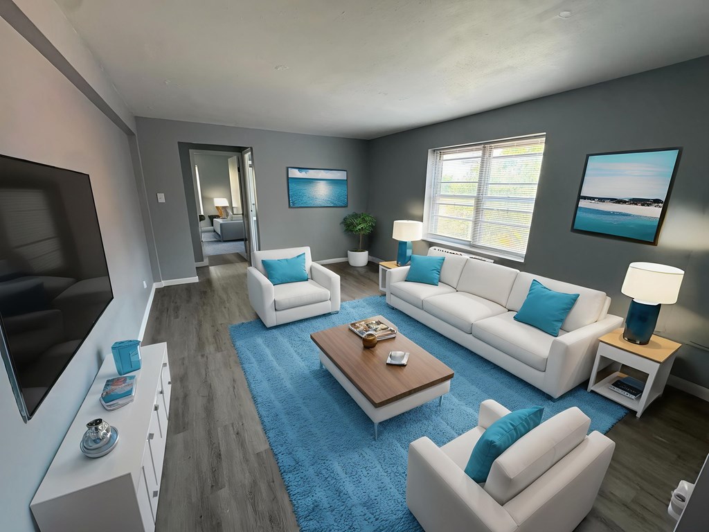 A modern living room with a white sofa set and a wooden coffee table.