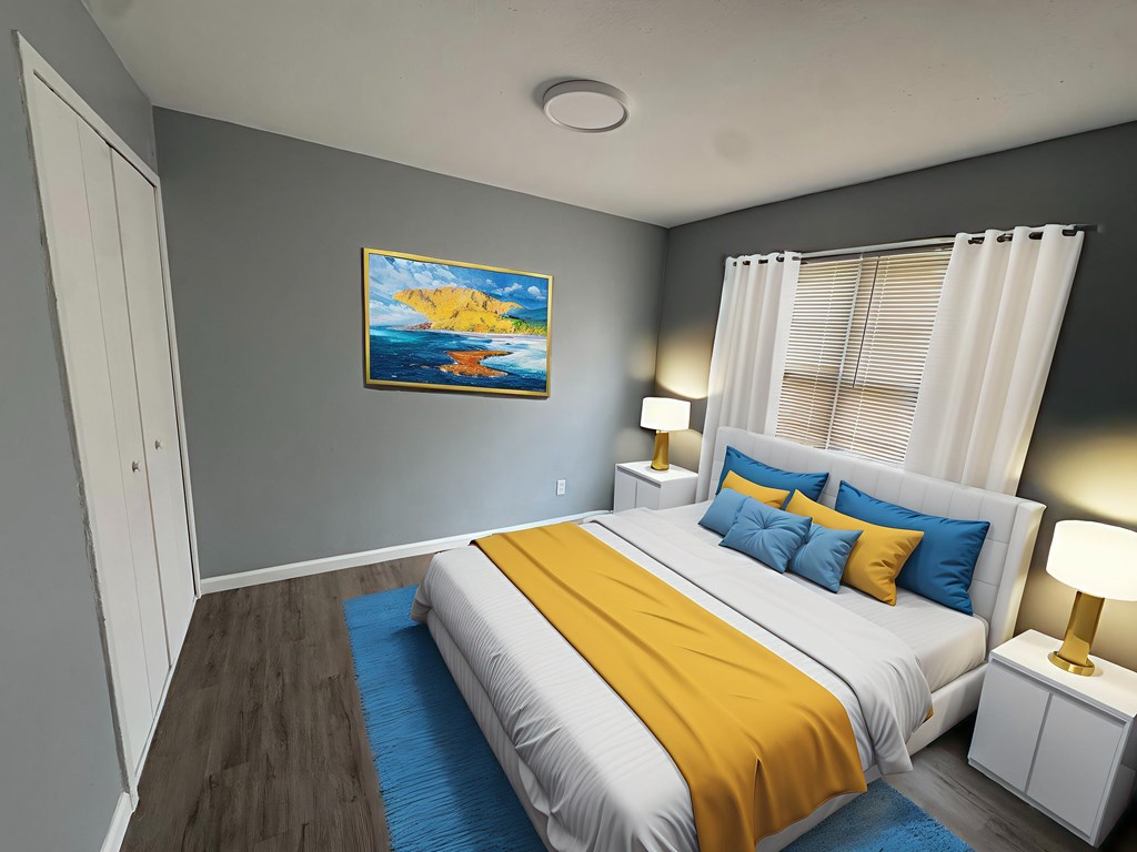 A bedroom with a bed, two lamps, and a painting on the wall.