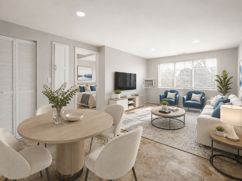 A modern living room with a round table and chairs.