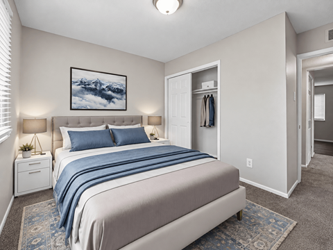 A bedroom with a large bed and a painting on the wall.