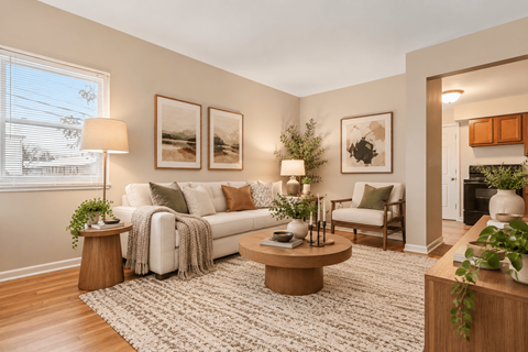 A living room with a white couch, a coffee table, and a rug.