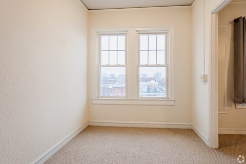 A room with a window and a door.