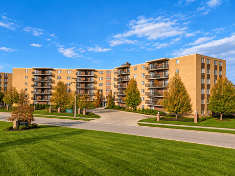 Apartment complex with a green lawn in front.
