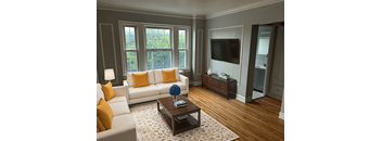 A living room with a white couch and a coffee table.