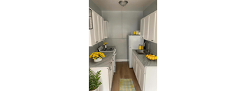 A kitchen with white cabinets and a grey counter top.