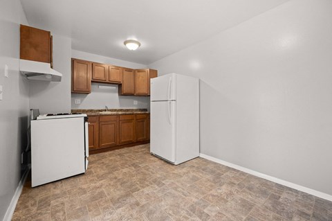 A kitchen with a white refrigerator and a white dishwasher.