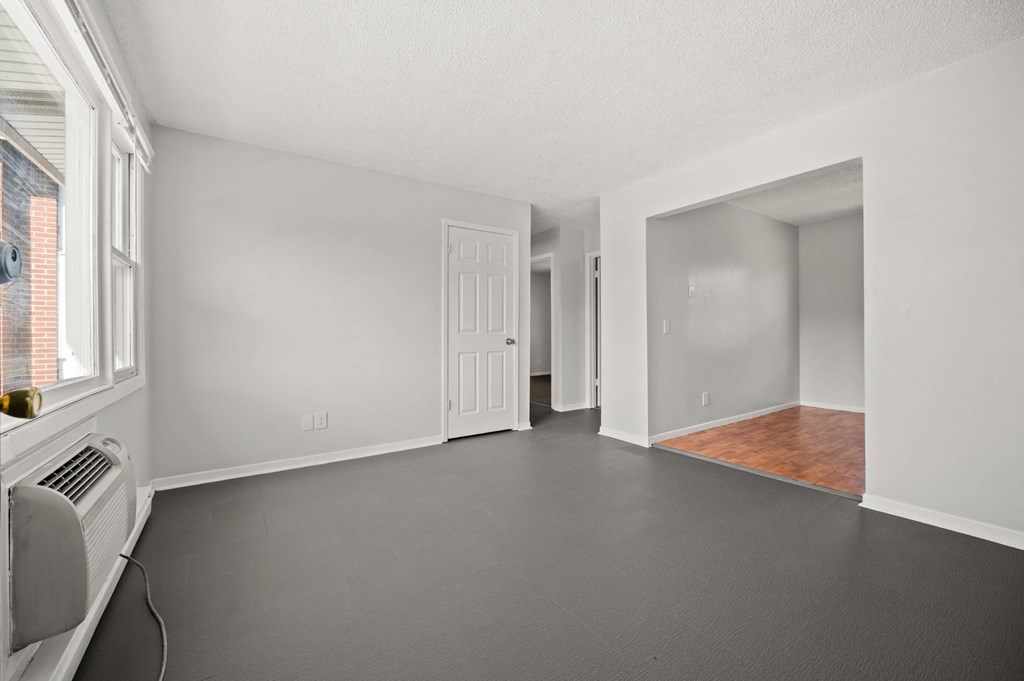 A room with white walls and a wooden floor.