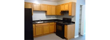 Kitchen with cabinetry at The Terraces at Dekalb, Dekalb, Illinois