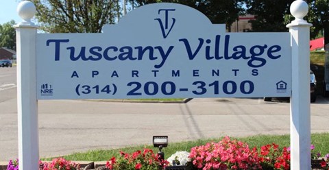 a sign for tuscan village apartments