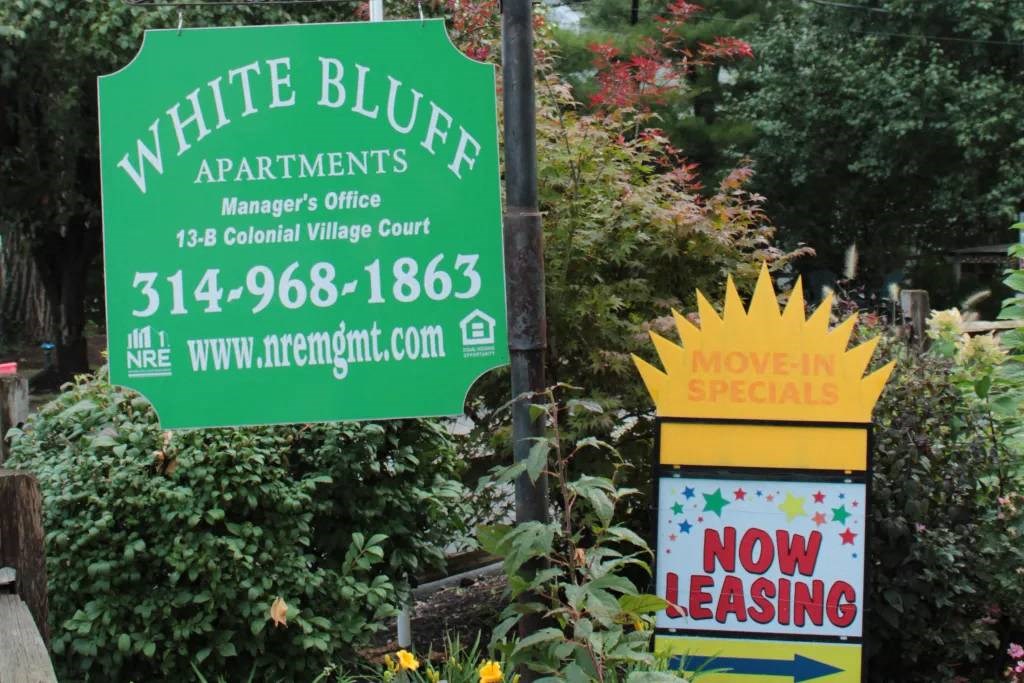 a sign that is in front of some flowers