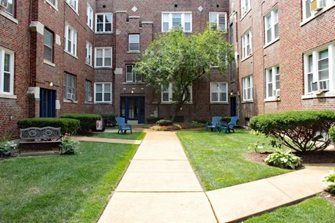 a sidewalk leading to an apartment building
